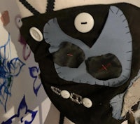 a mannequin wearing a mask with buttons on it