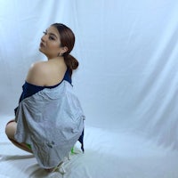 a woman crouching down on a white background