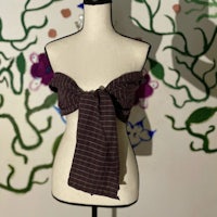 a mannequin wearing a brown and white striped scarf