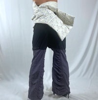 the back of a woman wearing ruffled pants