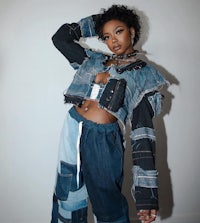 a woman in a denim jacket posing for a photo