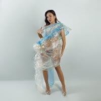 a woman wearing a dress made of plastic bags