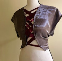 a mannequin with a brown and maroon top