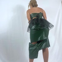 a woman wearing a green leather dress