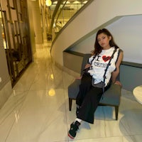 a woman sitting on a chair in a lobby