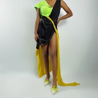 a woman in a black and yellow dress posing for a photo