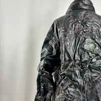 a black leather jacket with embroidery on it
