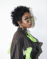 a black woman wearing glasses and a suit