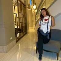 a woman sitting on a chair in a lobby