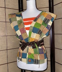 a mannequin with a patchwork top and belt