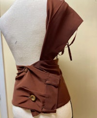 a mannequin wearing a brown top with buttons