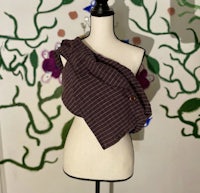 a mannequin wearing a brown and white striped sling
