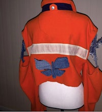 a mannequin with an orange and blue jacket on it