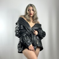 a woman posing in a black leather jacket