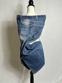 a pair of blue jeans on a mannequin