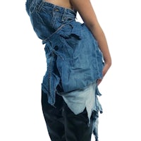 a woman wearing a denim overall dress