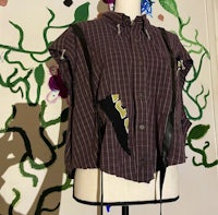 a mannequin wearing a shirt with patches on it